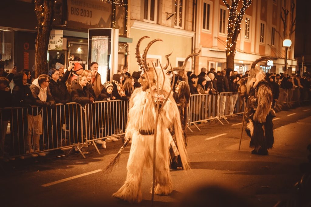 people-in-krampus-costumes-marching-in-a-street-parade-gqxfxmvewam